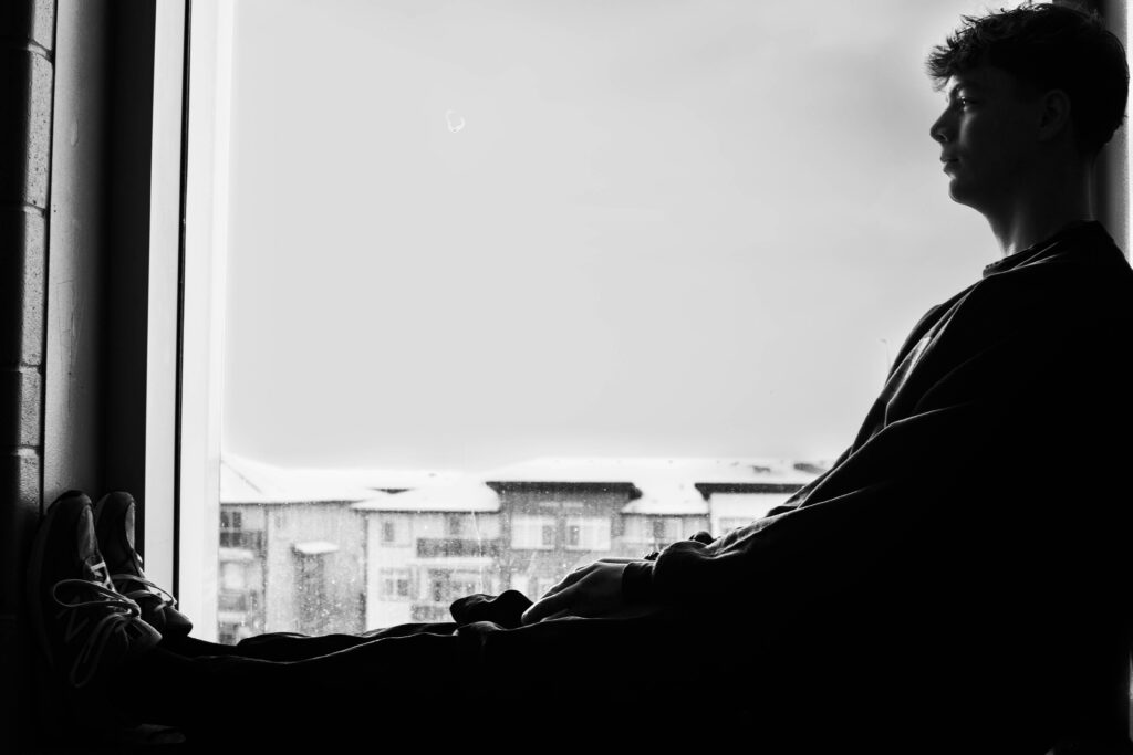 man sitting alone with a quiet inward expression