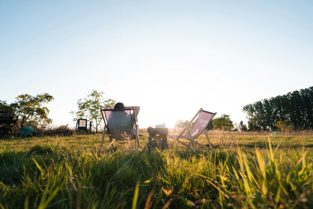 How to Recover from Burnout: What Actually Helps Adult resting quietly outside in natural light, representing the early stages of burnout recovery.