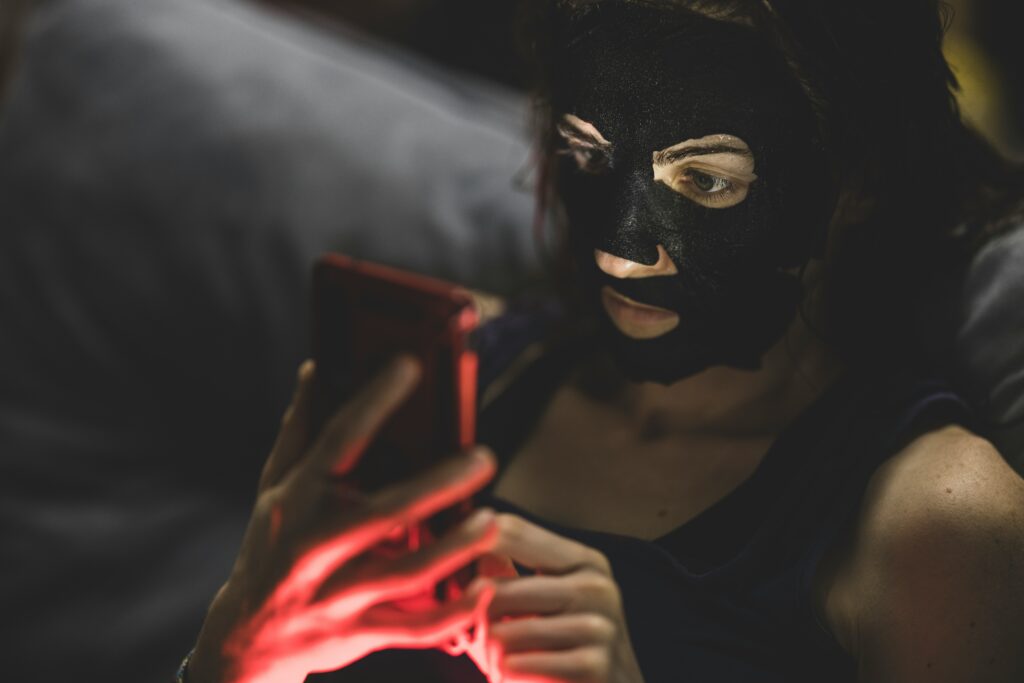 Can AI Chatbots Replace a Psychiatrist? What They Can (and Can't) Do for Your Mental Health A woman looking at a smartphone screen with a calm but thoughtful expression